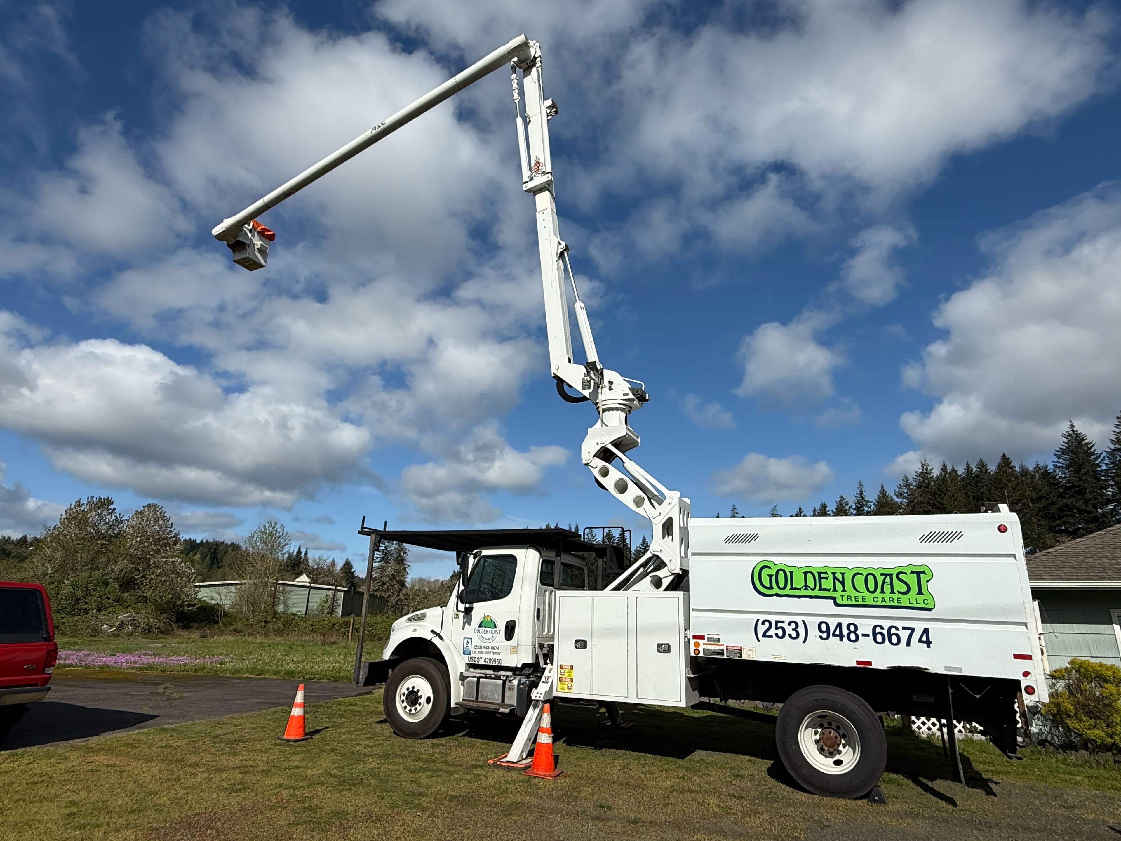 Golden Coast Tree Care bucket truck set up for tree service on residential property